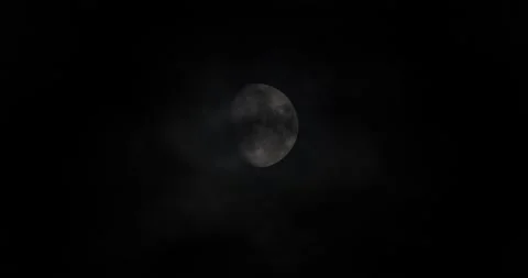 Dark clouds passing over almost full moon in the night sky Stock Footage 218412838