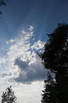 Dark clouds with rays of light shining Stock Photos