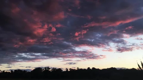 Dark clouds with a red glow at sunset Video stock 160188547