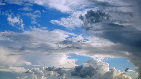 Dark clouds rolling in on a blue sky in spring. 4k60p Stock Footage 132223403