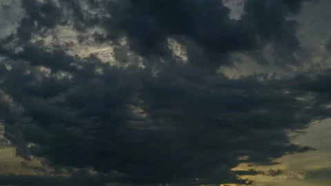 Dark clouds rush into the sun, closing and opening it. The sun's rays appear. Stock Footage 133345365