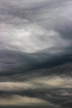 Dark clouds in the sky during a storm. The clouds are ominous and forebodin.. Stock Photos