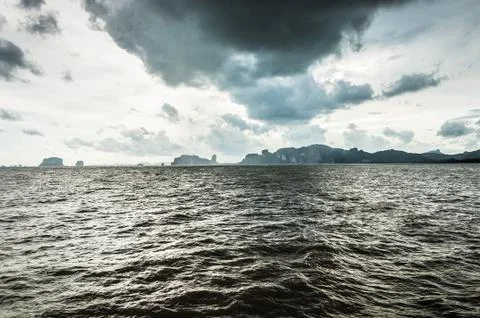 Dark clouds on the sky over dark ocean water Stock Photos
