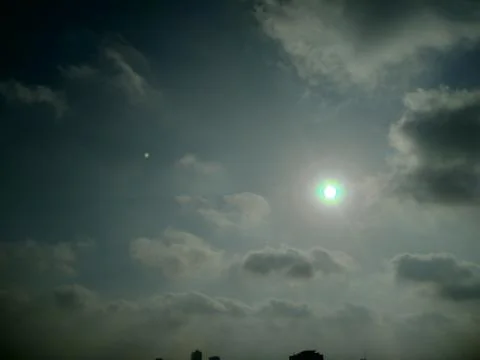 The dark clouds in the sky with sun Stock Photos