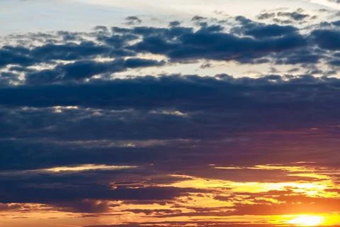 Dark clouds in the sky. Sunset on a background of storm clouds. Stock Photos