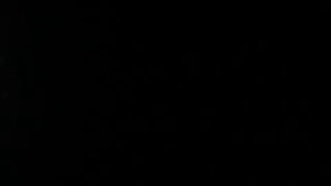 Dark clouds slowly moving through the full moon, shining on a black sky Stock Footage 98247098