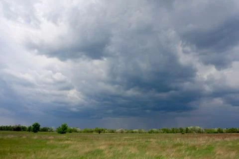 Dark clouds in steppe Stock Photos