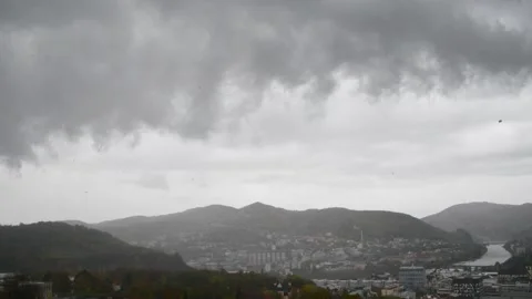 Dark clouds storm dramatic weather wind and leaves flying Video stock 145897310