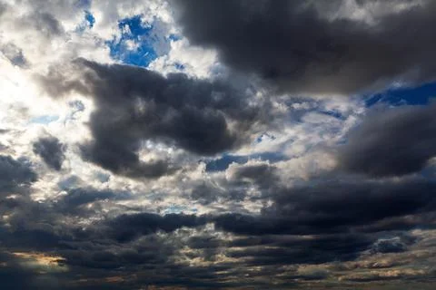 Dark clouds with sun light Stock Photos