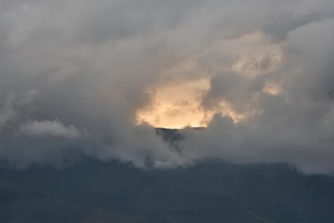 Dark Clouds With Sunlight Breaking. Intense Weather And Lightning Illuminating Stock Photos