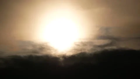 Dark clouds at sunrise - bright sun - time lapse cloudscape - sky background Stock Footage 151628635