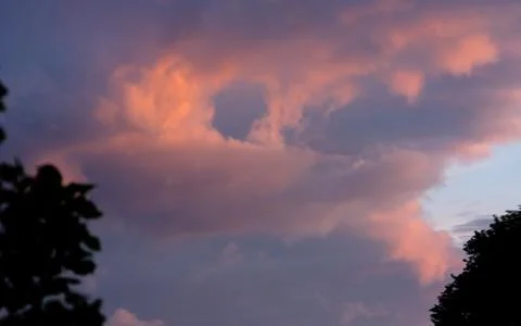 Dark clouds in sunset light Stock Photos