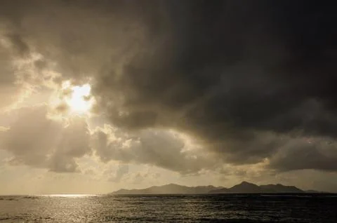 Dark clouds at sunset on the ocean Stock Photos