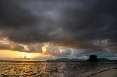 Dark clouds at sunset on the ocean Stock Photos