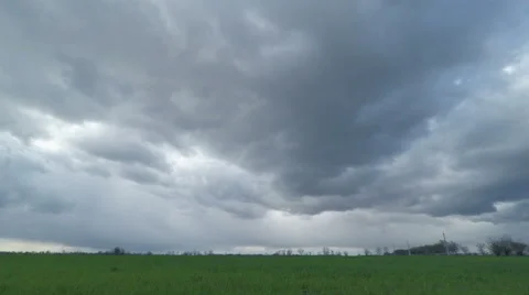 Dark Clouds Sweep Over the Green Field Stock Footage 49743386
