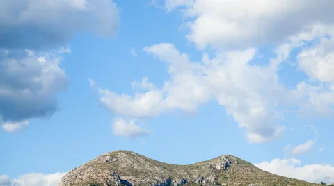 Dark clouds time lapse with mountains on a sunny day. 4k Stock-Footage 54778782