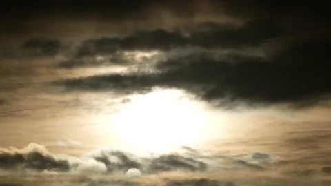 Dark clouds, white sun, golden sunlight at sunrise - sky background - Time Lapse Stock Footage 154549648