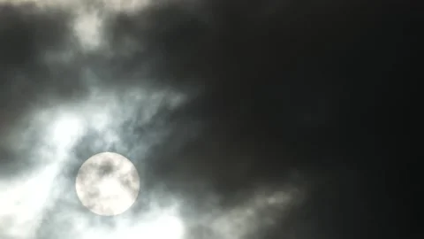 Dark clouds, white sun, golden sunlight at sunrise - sky background - Time Lapse Stock Footage 154630555