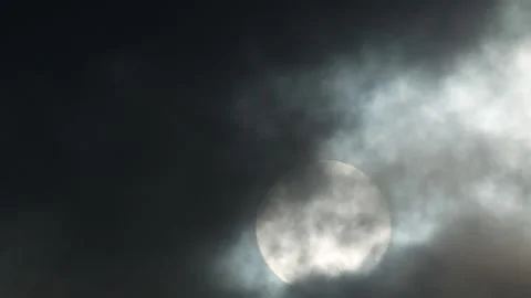 Dark clouds, white sun, golden sunlight at sunrise - sky background - Time Lapse Stock Footage 154631054