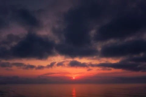 Dark cloudscape sunset over the sea Stock Photos