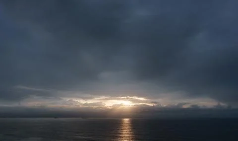 Dark cloudscape sunset over the sea Stock Photos