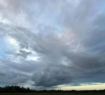 Dark cloudy sky over a flat landscape with storm clouds Stock Photos