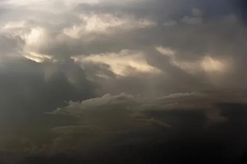Dark cloudy sky with storm clouds and moody atmosphere Stock Photos