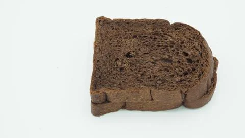 Dark cocoa bread on white background. It is a natural whole grain. Stock Photos