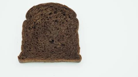 Dark cocoa bread on white background. It is a natural whole grain. Stock Photos