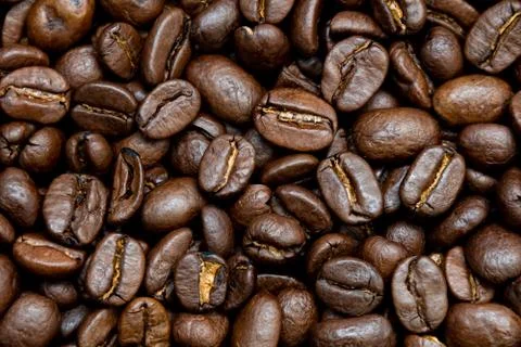 Dark coffee beans background texture of roasted seeds close up Stock Photos
