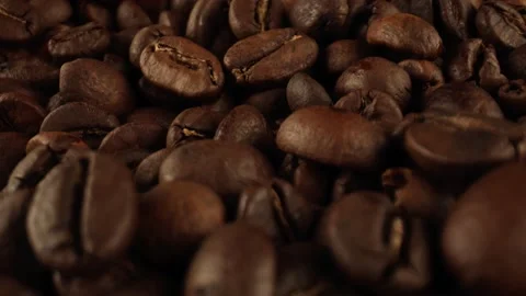 Dark coffee beans, close-up. Coffee beans increased in volume after roasting Stock Footage 164146353