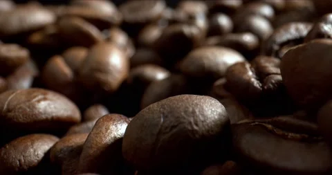 Dark Coffee Grains. Close-up dolly shot. Beautiful seeds of coffee. Stock Footage 142766936
