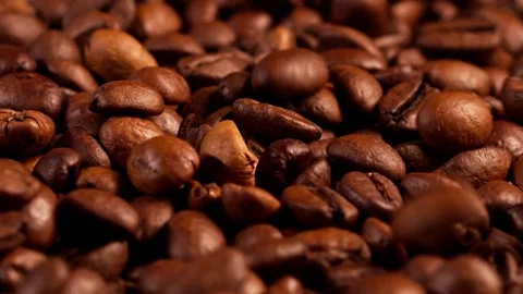 Dark Coffee Grains. Rotating and falling. Coffee beans. Close up of seeds of Stock Footage 152890004