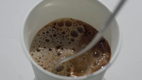 Dark Coffee or Cola Liquid with Bubbles in White Bowl Stock Footage 340243520