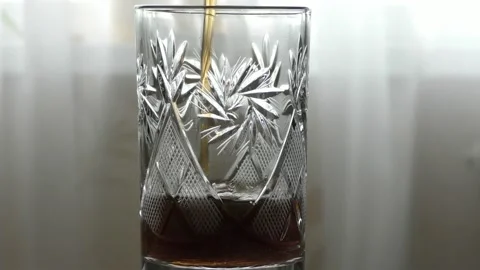 A dark-colored drink is poured into a transparent glass. healthy food concept Stock Footage 147941967