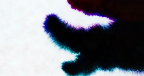 Dark colored ink spilling and bleeding on white paper background Video stock 88418765