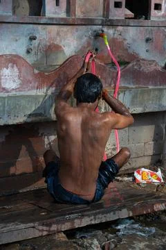 Dark complexion working man taking a bath outdoors Stock Photos