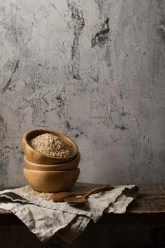 Dark composition with brown rice Stock Photos