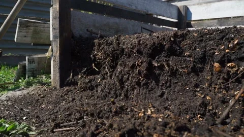 Dark compost pile in wooden compost bin in garden Stock-Footage 342604051