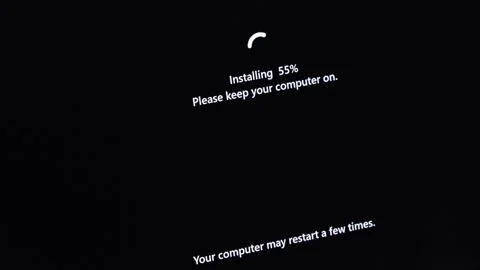 Dark computer screen shows Installing 55% with Please keep your computer on.. Stock Footage 314389071