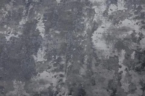 Dark concrete surface with mottled gray and charcoal tones forming an irregular Stock Photos