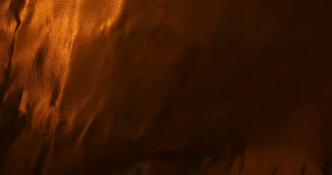 Dark copper metallic foil background with warm golden reflections 動画素材 345677302