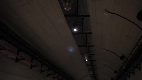 A dark corridor with flashing and broken lamps on the ceiling. Bomb shelter. Stock Footage 250598606