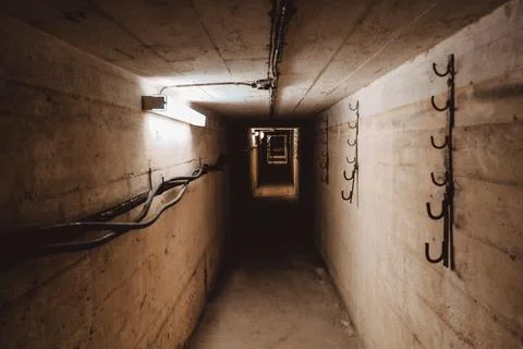Dark corridor of old abandoned Soviet underground bunker. Defocused Stock Photos