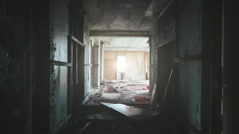 Dark corridor in old broken building with sun light in end Video stock 249157680