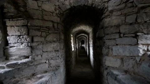 Dark corridors in an ancient castle. long stone corridor with windows in a Video stock 190073747