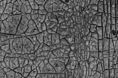 Dark cracked texture background. Old sheet of rubber. Stock Photos
