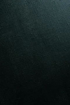 Dark creative background: black primed linen canvas, uneven lighting, color t Stock Photos
