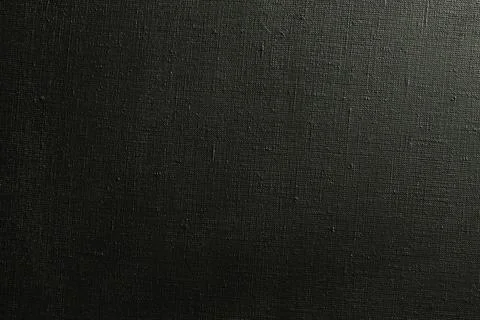 Dark creative background: black primed linen canvas, uneven lighting, color t Stock Photos