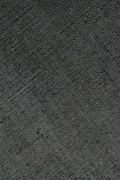 Dark creative background: black primed linen canvas, uneven lighting, toning Foto stock